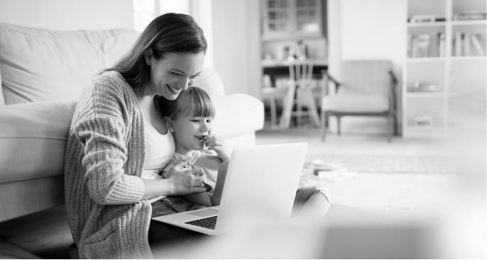 Woman and little girl looking at laptop