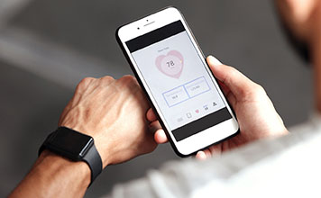 A man tracks his heartrate with an app