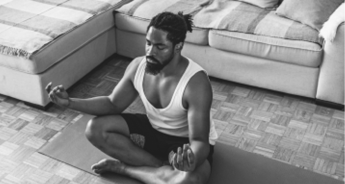 Man sits and meditates after doing yoga