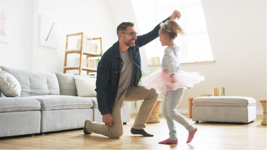 A father dances with his daughter