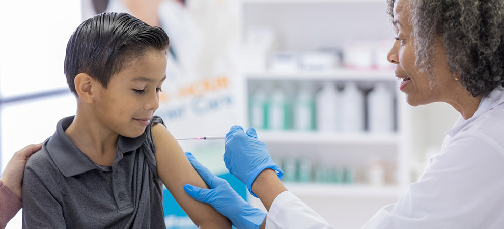   A photo of a doctor giving a vaccine to a child