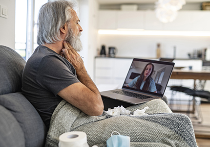 A sick man talks with a doctor online.