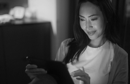 woman with tablet at night time