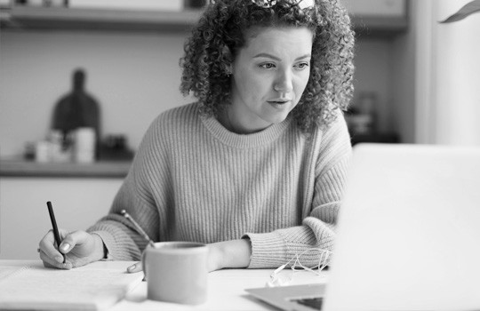 A woman looks over her benefits online.