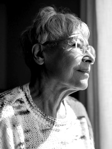 An older women looking out window