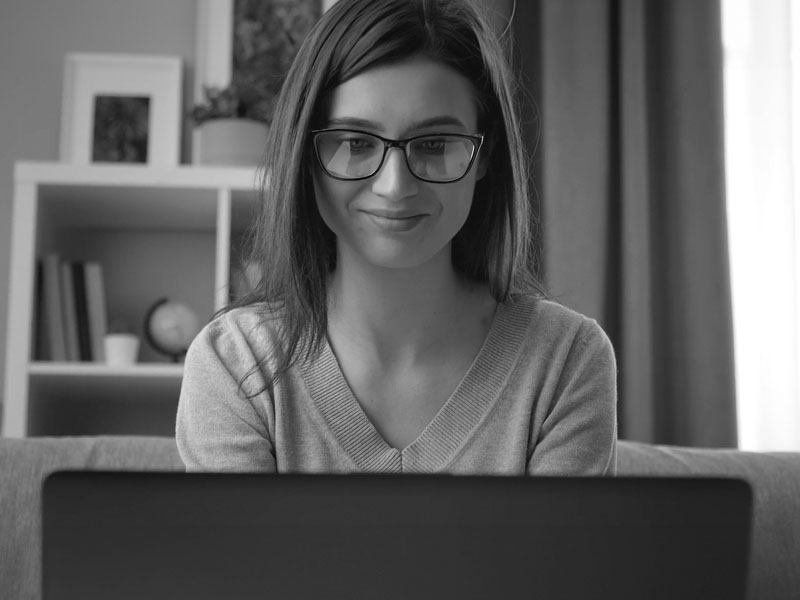 Close up of a young woman using a laptop.