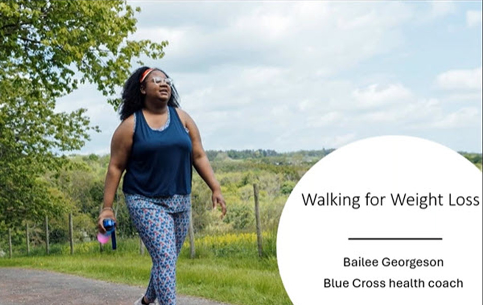 A woman walks along a nature trail. 