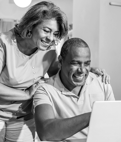 Senior couple looking for medicare health plans on laptop together