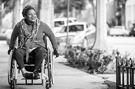 A person in a wheelchair tours the city. 