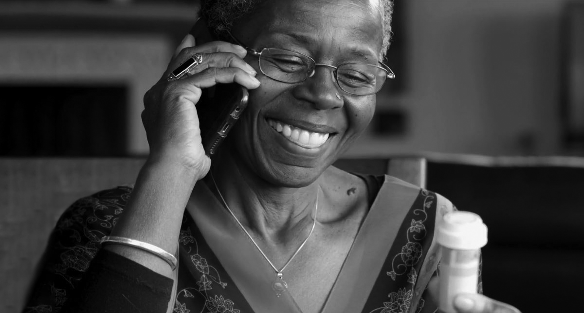 A woman smiles while talking on the phone